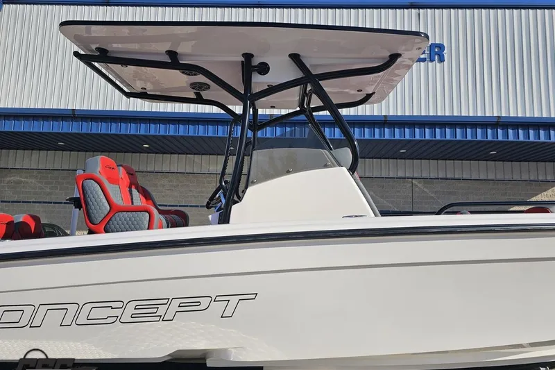 Slide: The Image of 2025 Concept 27' CC boat with red and gray seating, docked near a building. - 4
