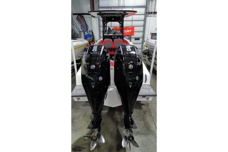 Slide: The Image of 2025 Concept 27' CC boat with dual outboard engines in a showroom. - 44