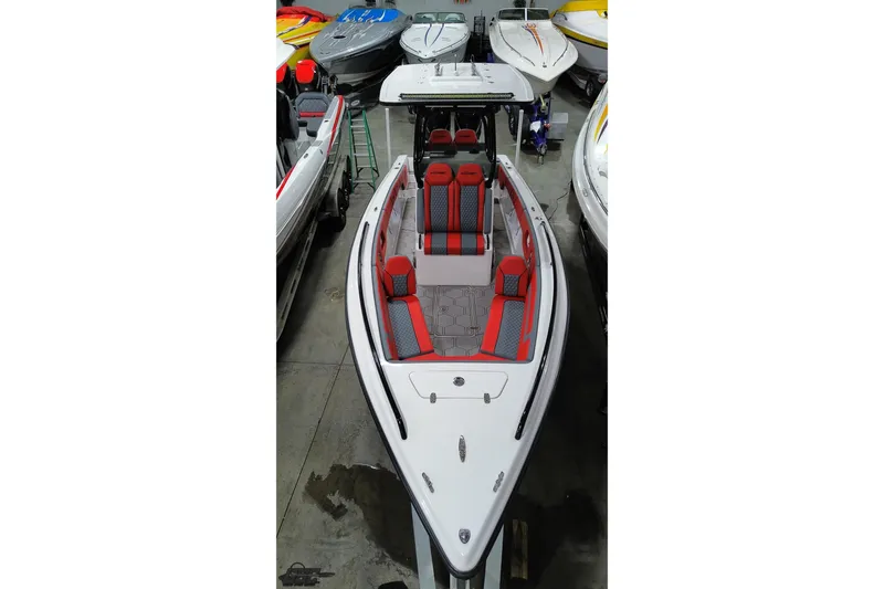 Slide: The Image of 2025 Concept 27' CC boat with red and gray seating in showroom. - 48