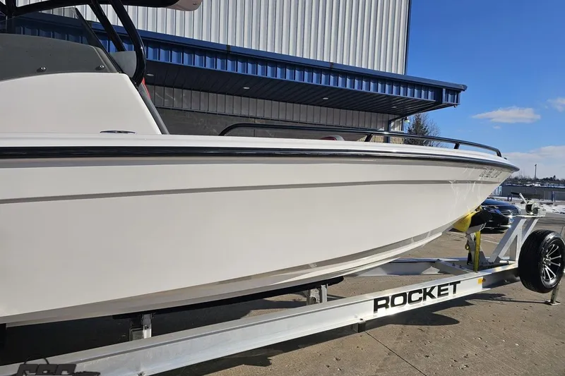 Slide: The Image of 2025 Concept 27' CC boat on trailer, parked outside a building. - 5