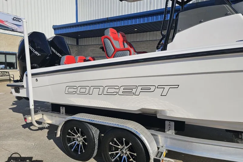 Slide: The Image of 2025 Concept 27' CC boat on trailer with red seats and Mercury engines. - 6