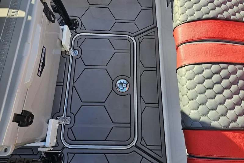 Slide: The Image of 2025 Concept 27' CC boat interior with hexagonal flooring and red-black seating. - 63