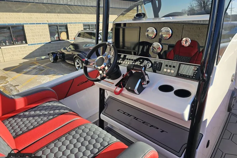 Slide: The Image of 2025 Concept 27' CC boat interior with modern dashboard and red seating. - 67