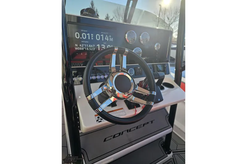 Slide: The Image of 2025 Concept 27' CC boat dashboard with modern steering wheel and digital display. - 70
