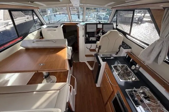 Slide: The Image of Interior of 2026 Cutwater C-288 CB boat with modern kitchen and seating area. - 3