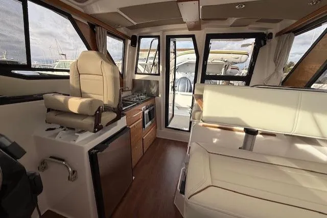 Slide: The Image of Interior of 2026 Cutwater C-288 CB boat with seating, kitchenette, and helm station. - 4