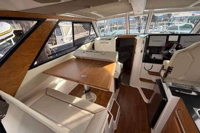 Slide: The Image of Interior of 2026 Cutwater C-288 CB boat with seating, table, and navigation equipment. - 5