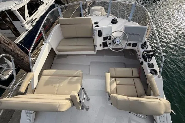 Slide: The Image of 2026 Cutwater C-288 CB boat interior with beige seating and Garmin navigation system. - 9