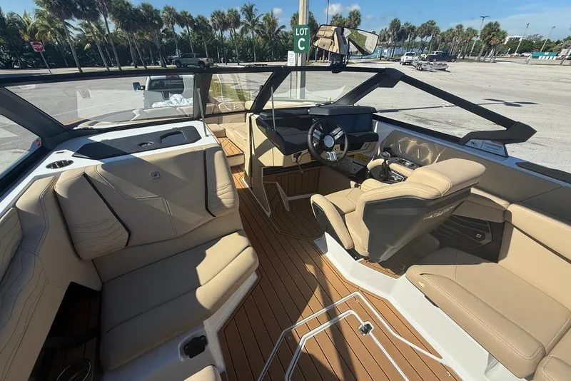 Slide: The Image of 2026 Nautique Super Air Nautique G25 Coastal Edition interior with tan seating and modern dashboard. - 4