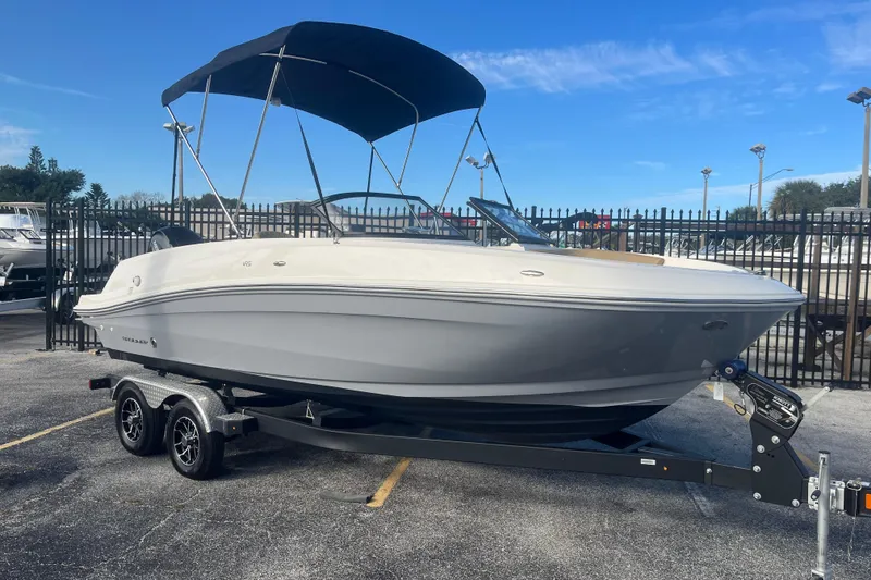 Slide: The Image of 2023 Bayliner VR5 Bowrider OB on trailer with canopy, parked outdoors. - 4