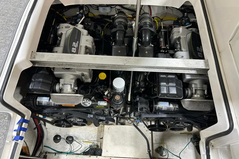 Slide: The Image of Engine compartment of a 2012 Chaparral 327 SSX boat, showcasing dual engines. - 100