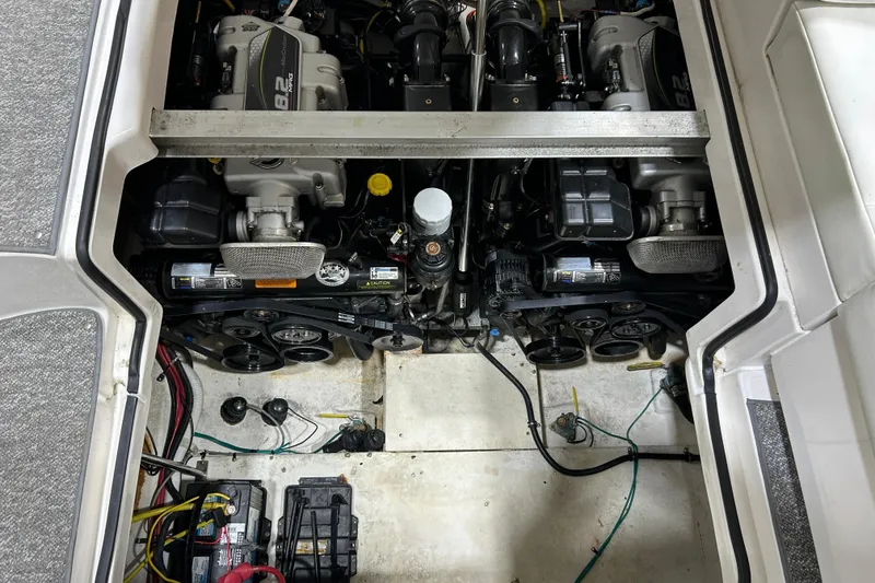 Slide: The Image of Engine compartment of a 2012 Chaparral 327 SSX boat, featuring dual engines. - 103