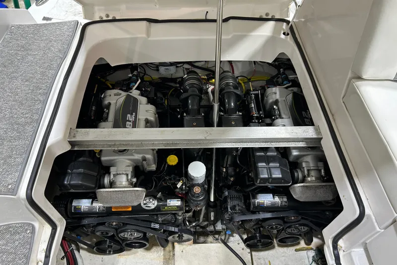 Slide: The Image of Engine compartment of 2012 Chaparral 327 SSX boat, showcasing dual engines and mechanical components. - 105