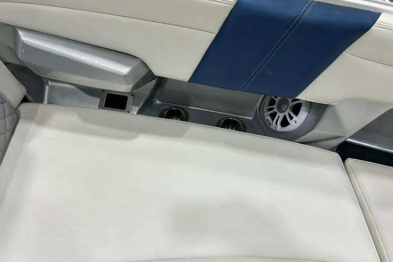 Slide: The Image of 2012 Chaparral 327 SSX boat interior with speaker and cup holders. - 109