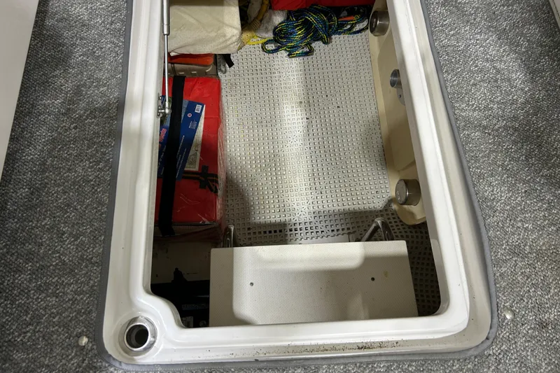 Slide: The Image of 2012 Chaparral 327 SSX storage compartment with ropes and equipment. - 110