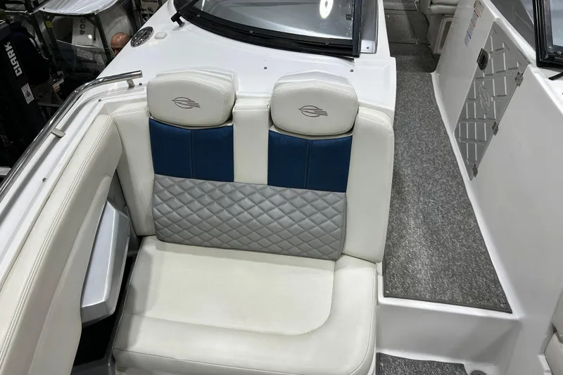 Slide: The Image of 2012 Chaparral 327 SSX boat interior with white and blue seating. - 24