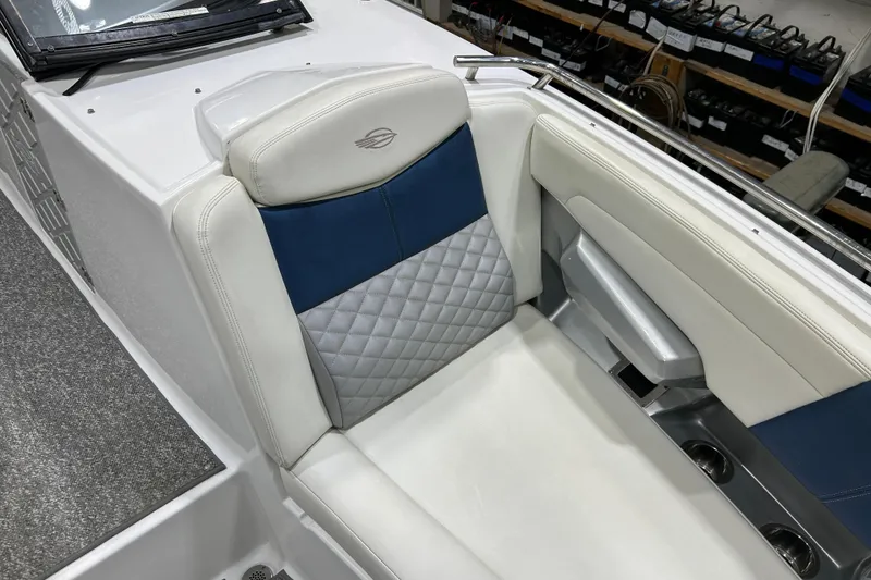 Slide: The Image of 2012 Chaparral 327 SSX boat seat with blue and gray quilted upholstery. - 27