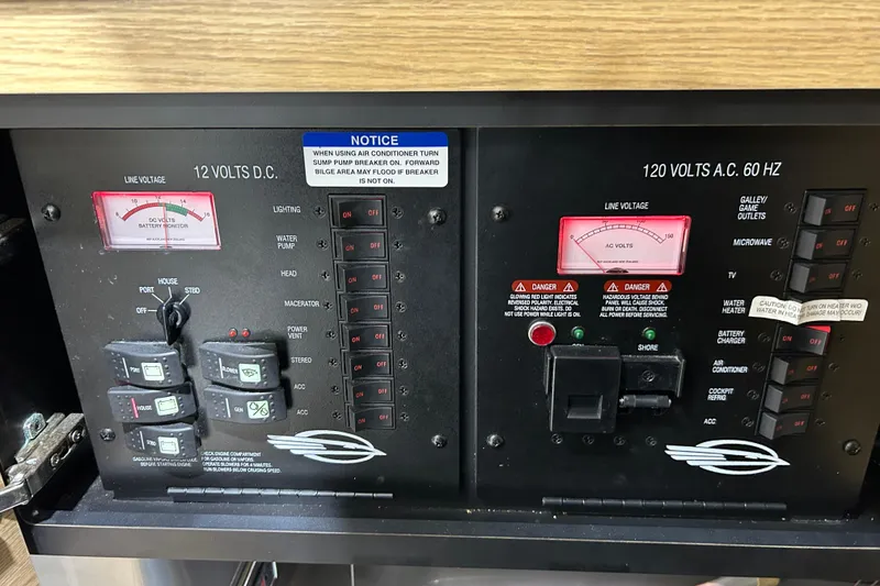 Slide: The Image of Electrical control panel of a 2012 Chaparral 327 SSX boat, showing voltage meters and switches. - 33