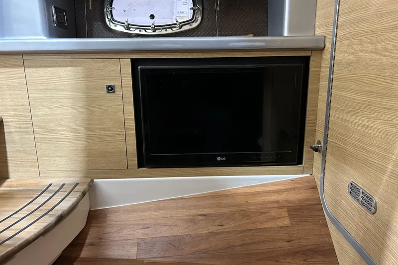 Slide: The Image of Interior of 2012 Chaparral 327 SSX with built-in LG TV and wood paneling. - 40