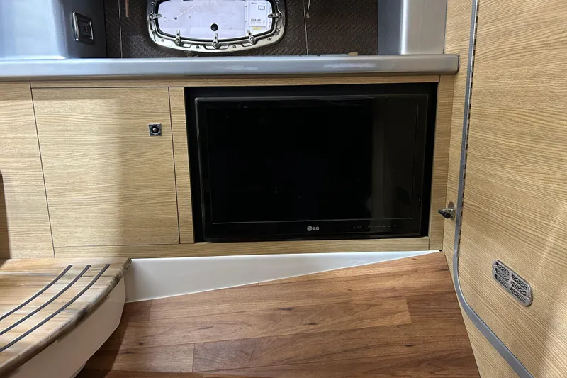 Slide: The Image of Interior of 2012 Chaparral 327 SSX with built-in LG TV and wood paneling. - 41