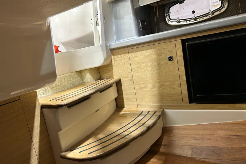 Slide: The Image of 2012 Chaparral 327 SSX interior with wooden steps and cabinetry. - 42