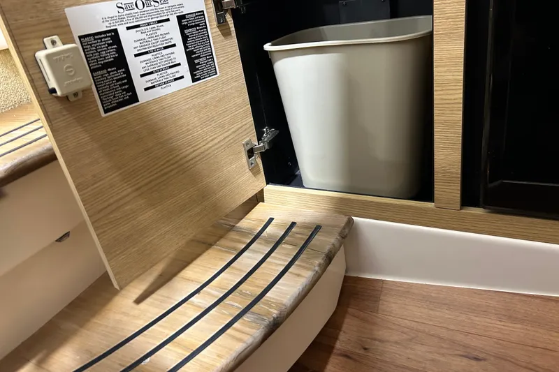 Slide: The Image of 2012 Chaparral 327 SSX interior with open cabinet and trash bin. - 43