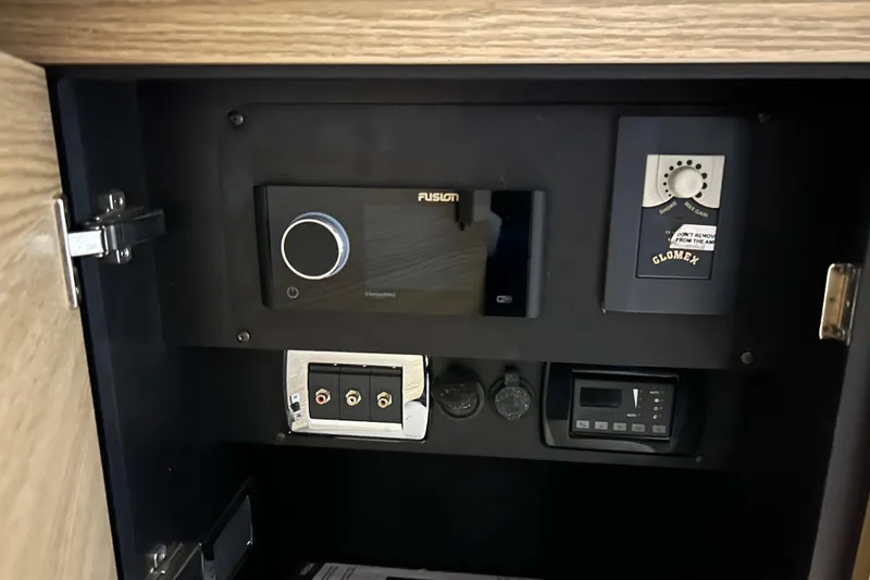 Slide: The Image of Control panel inside 2012 Chaparral 327 SSX boat, featuring Fusion and Glomex equipment. - 44