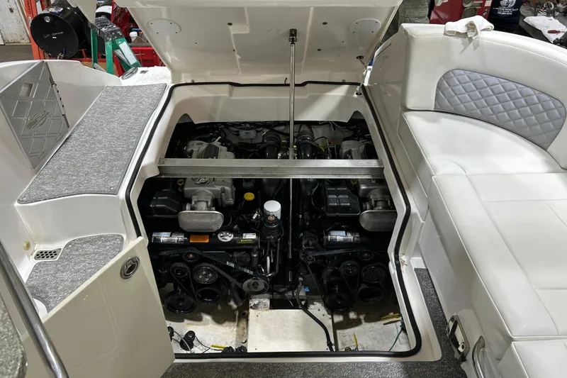 Slide: The Image of 2012 Chaparral 327 SSX boat engine compartment with open hatch, showcasing dual engines. - 51