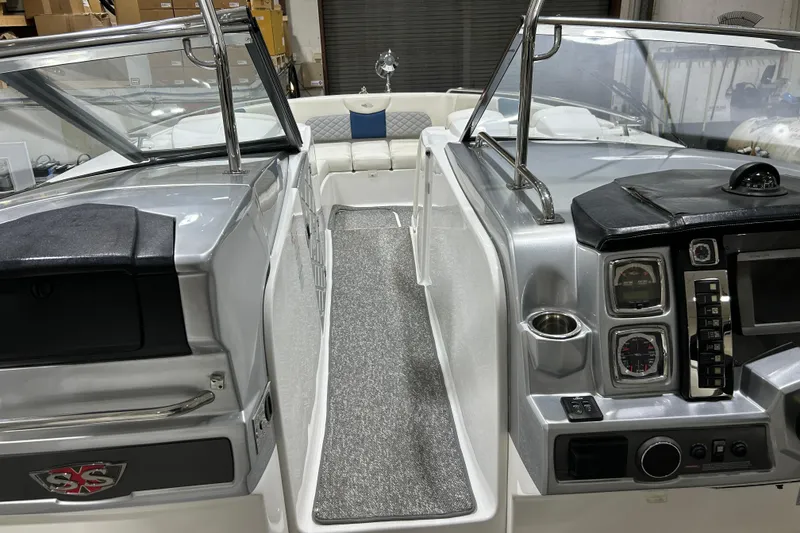 Slide: The Image of 2012 Chaparral 327 SSX boat interior with dashboard and seating area. - 57