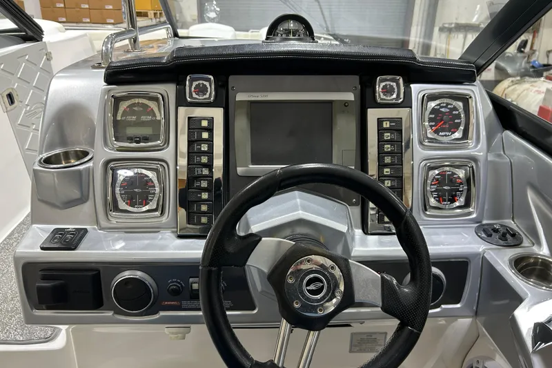 Slide: The Image of Cockpit of 2012 Chaparral 327 SSX boat with steering wheel and control panel. - 61