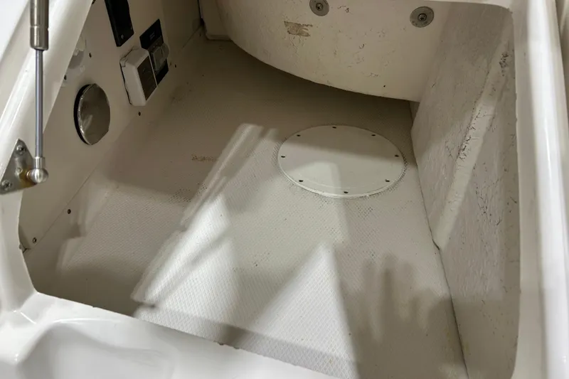 Slide: The Image of 2012 Chaparral 327 SSX boat interior showing storage compartment and control panel. - 70