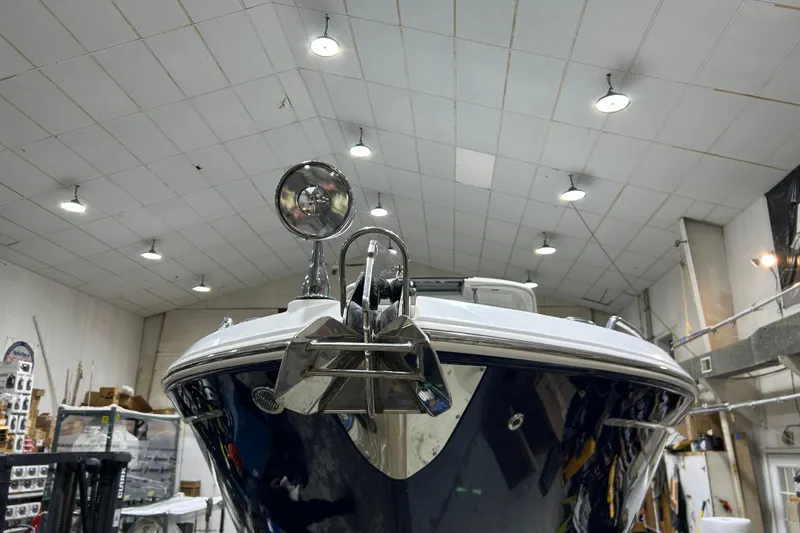 Slide: The Image of 2012 Chaparral 327 SSX boat in indoor storage, showcasing its sleek bow design. - 75