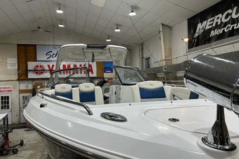 Slide: The Image of 2012 Chaparral 327 SSX boat in showroom, featuring sleek design and luxurious seating. - 76