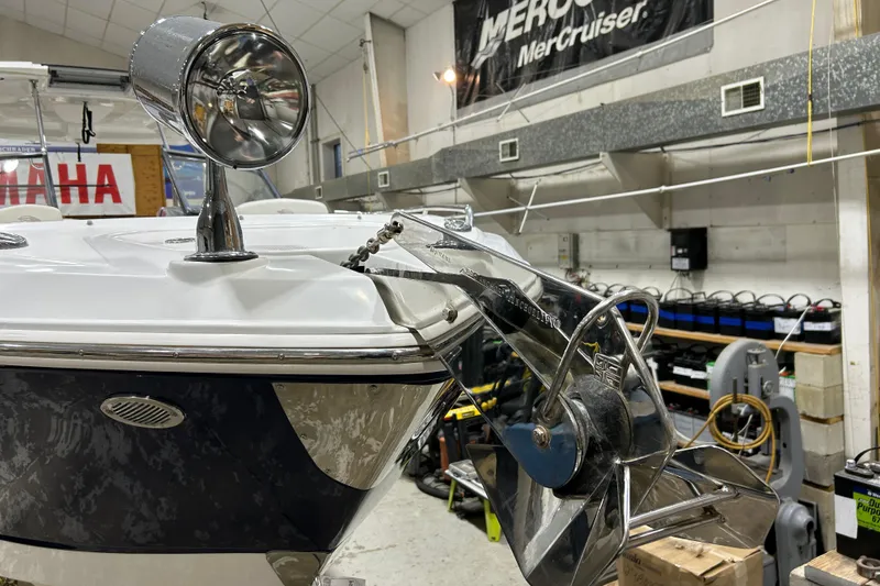 Slide: The Image of 2012 Chaparral 327 SSX boat in a workshop, featuring anchor and spotlight. - 77