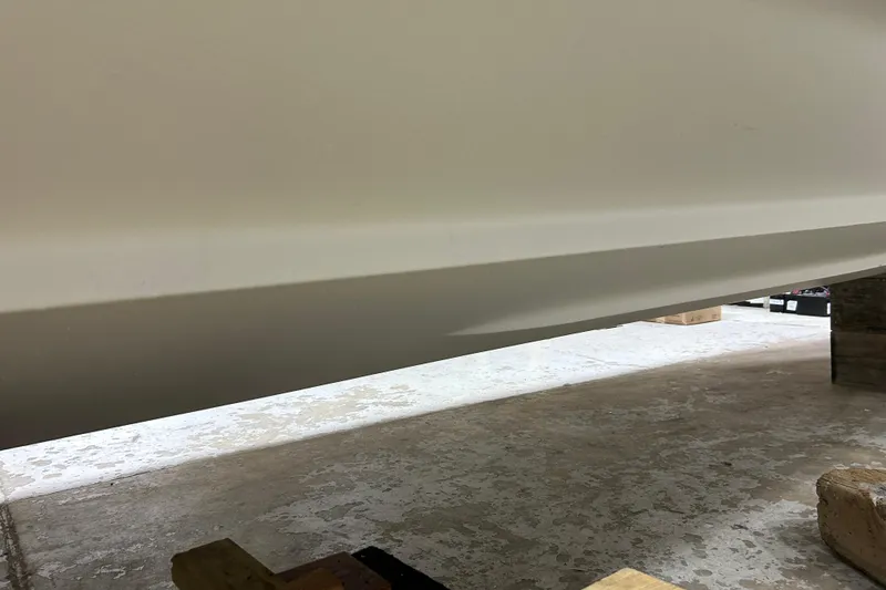 Slide: The Image of 2012 Chaparral 327 SSX boat hull in storage, showcasing sleek design and craftsmanship. - 83