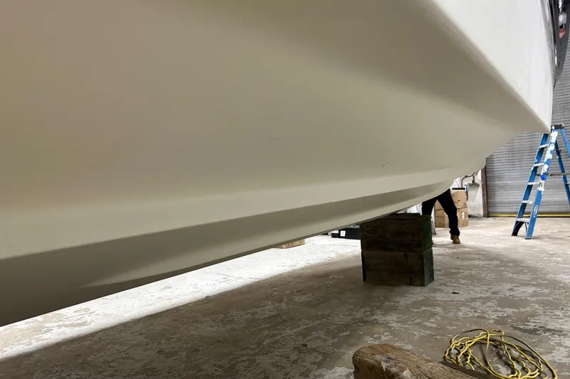 Slide: The Image of 2012 Chaparral 327 SSX boat hull in a workshop setting. - 84