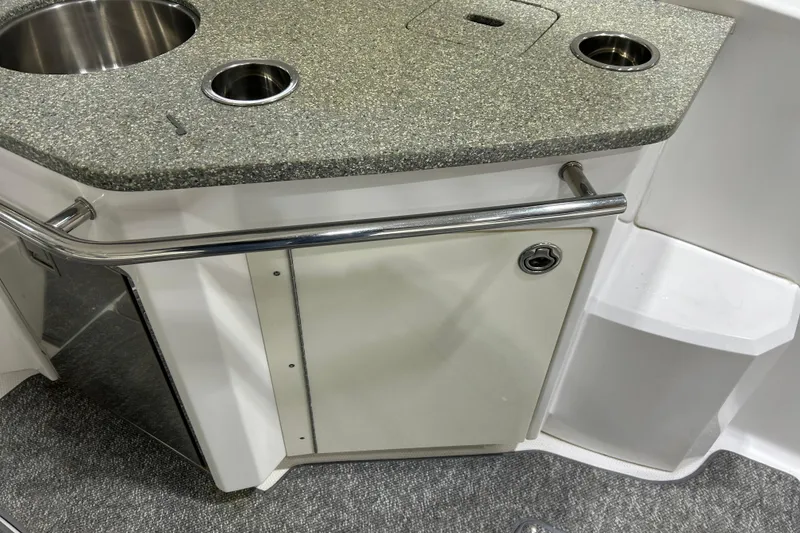 Slide: The Image of 2012 Chaparral 327 SSX boat kitchenette with stainless steel sink and granite countertop. - 90