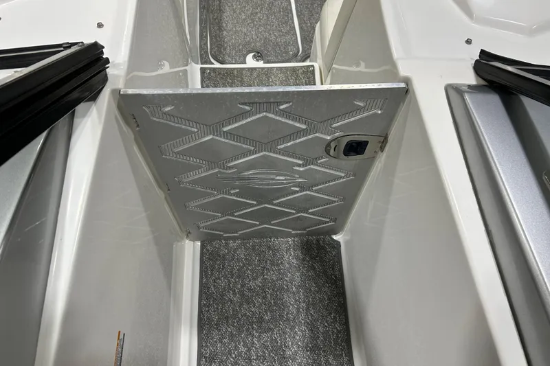 Slide: The Image of 2012 Chaparral 327 SSX boat interior with textured flooring and storage compartment. - 93