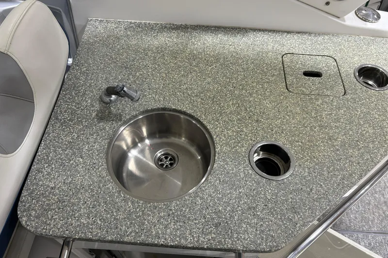 Slide: The Image of Granite countertop with sink and faucet on 2012 Chaparral 327 SSX boat. - 94
