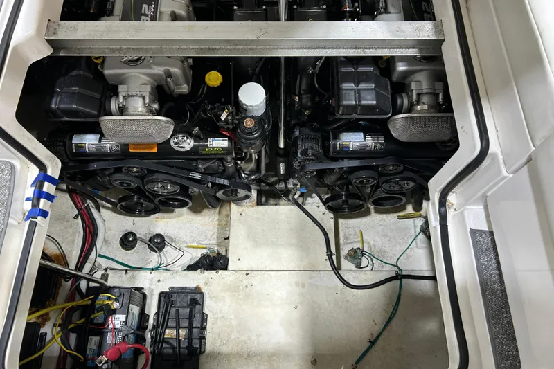 Slide: The Image of Engine compartment of a 2012 Chaparral 327 SSX boat, showing dual engines and battery setup. - 95