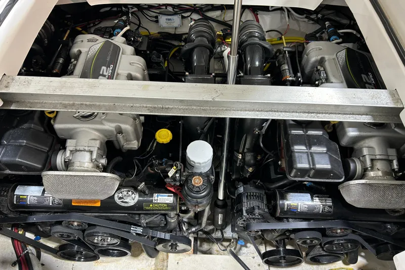 Slide: The Image of Engine compartment of a 2012 Chaparral 327 SSX boat, showcasing dual engines. - 96