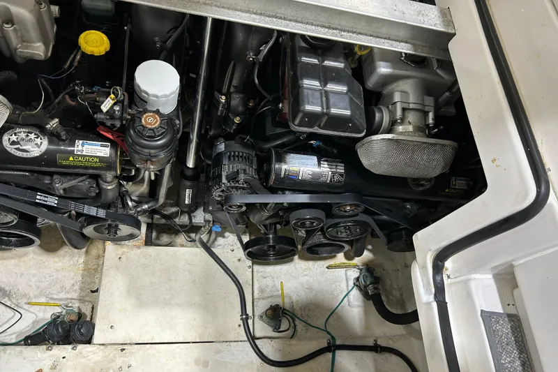 Slide: The Image of Engine compartment of a 2012 Chaparral 327 SSX boat, showing belts and components. - 97