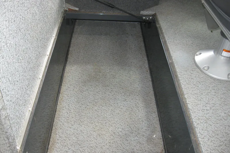 Slide: The Image of 2021 Lund 1875 Crossover XS interior storage compartment with carpeted flooring. - 10