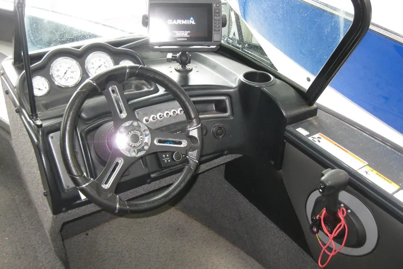Slide: The Image of 2021 Lund 1875 Crossover XS boat dashboard with Garmin GPS and steering wheel. - 12