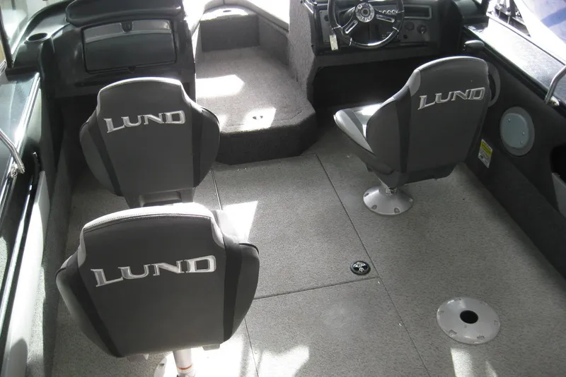 Slide: The Image of 2021 Lund 1875 Crossover XS boat interior with three branded seats and steering console. - 6