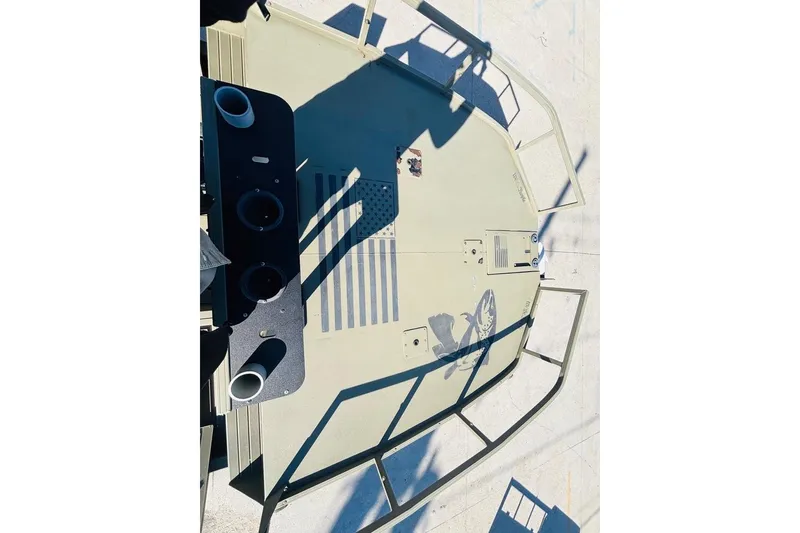 Slide: The Image of 2017 Tracker Grizzly 2072 MVX CC Sportsman boat deck with cup holders and fish graphic. - 16