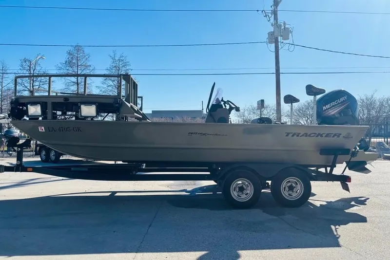 Slide: The Image of 2017 Tracker Grizzly 2072 MVX CC Sportsman boat on trailer, side view, outdoors. - 6