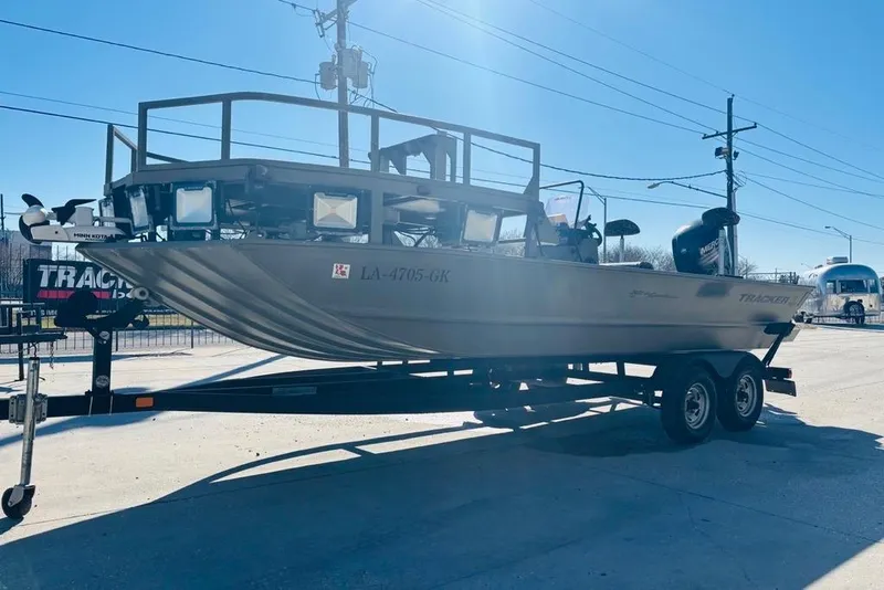 Slide: The Image of 2017 Tracker Grizzly 2072 MVX CC Sportsman boat on trailer, parked outdoors. - 7
