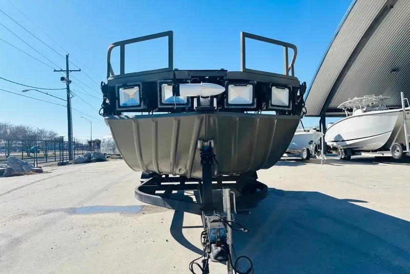 Slide: The Image of 2017 Tracker Grizzly 2072 MVX CC Sportsman boat on trailer, parked outdoors. - 8