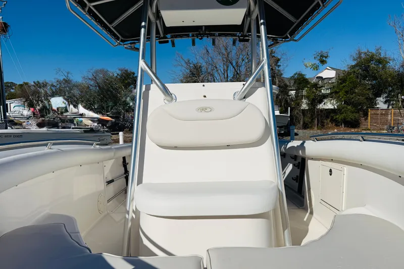 Slide: The Image of 2005 Robalo R220 Center Console boat interior with seating and console view. - 2
